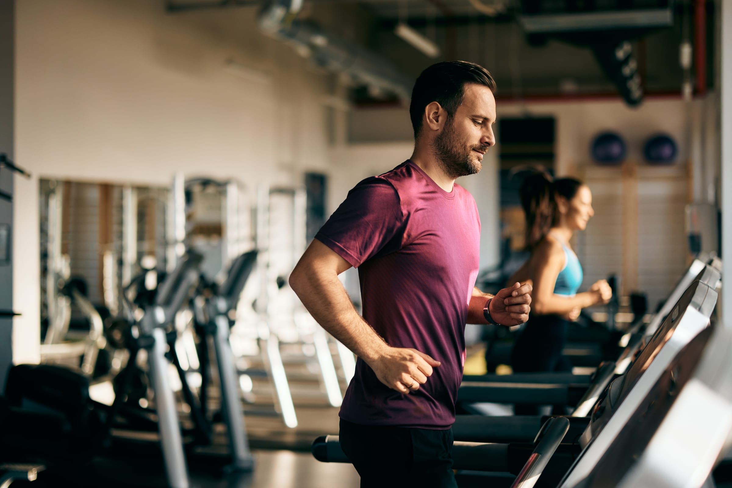 Man running on a treadmill in a community fitness center