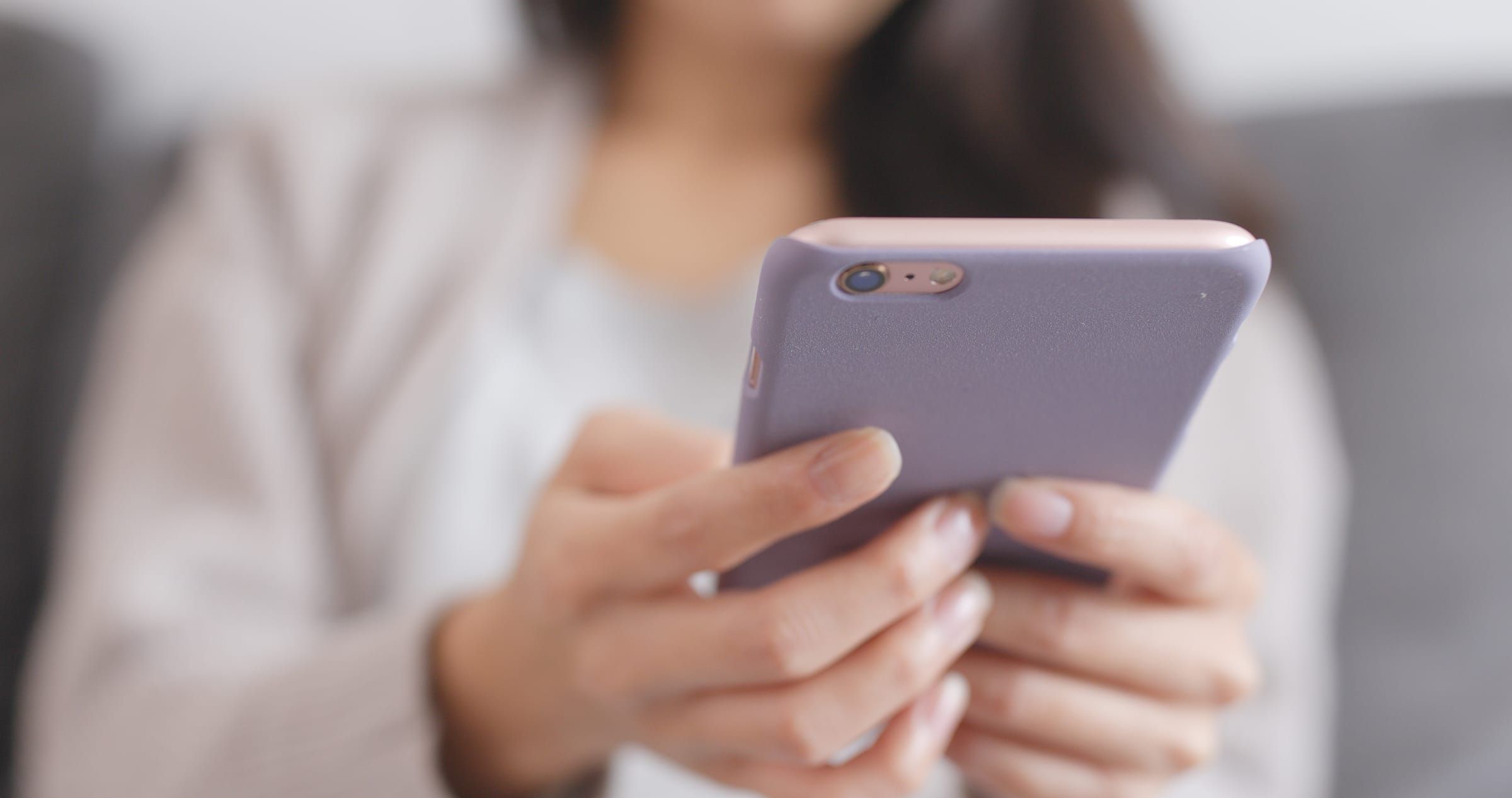 Hands holding a smartphone running the Operate Fit mobile app