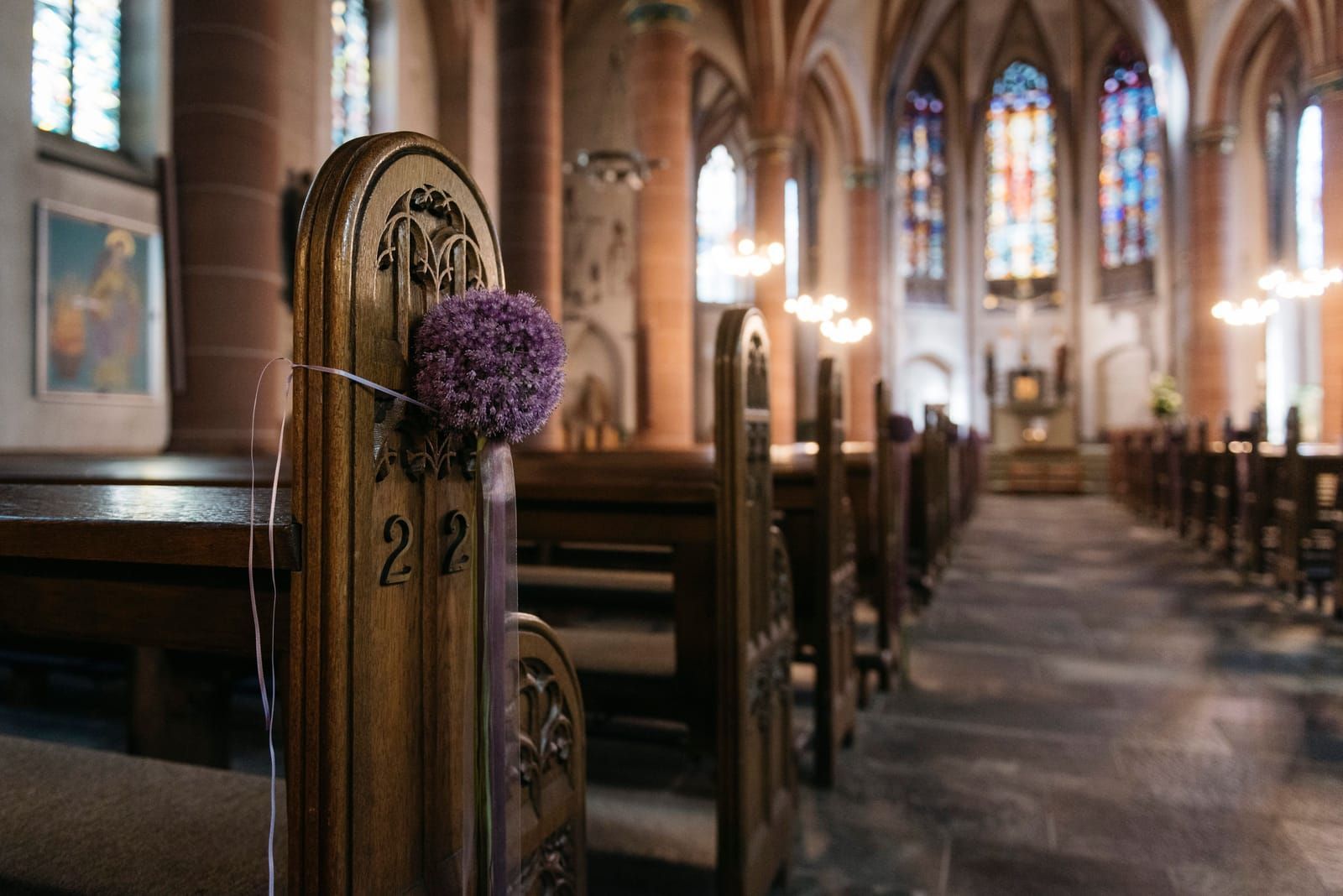 Wooden pews inside a sunlit church sanctuary