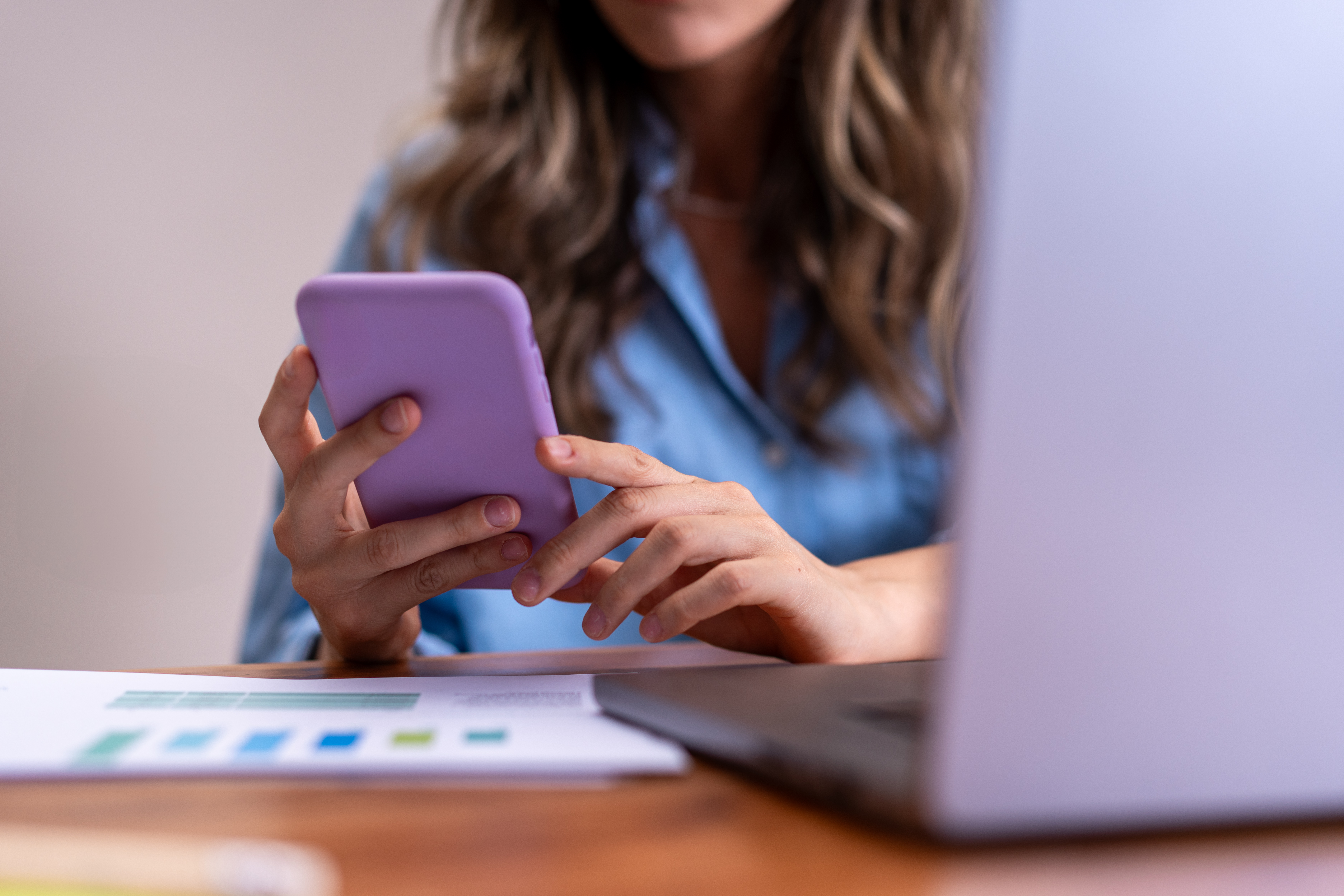 Staff member using Operate Fit on a smartphone at a desk